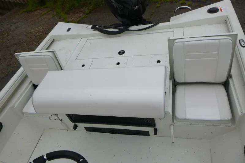 Slide: The Image of 2025 Ranger RB210 boat interior with white seating and storage compartments. - 16