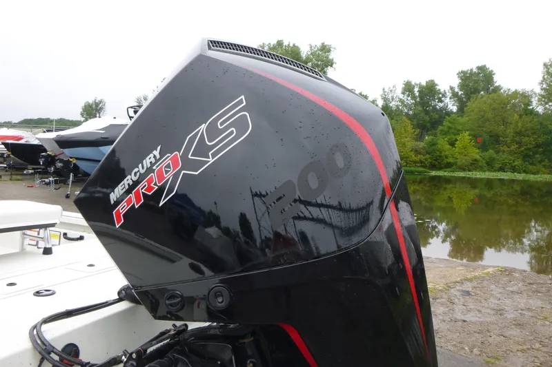 Slide: The Image of Mercury Pro XS outboard motor on 2025 Ranger RB210 boat by a lake. - 17