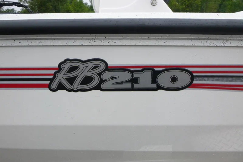 Slide: The Image of 2025 Ranger RB210 boat logo with red and black stripes on white surface. - 18