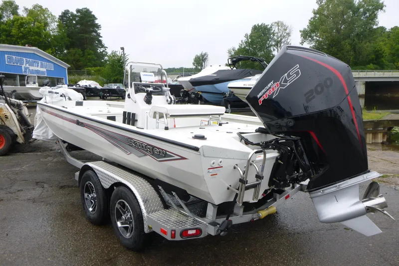 Slide: The Image of 2025 Ranger RB210 boat with Mercury Pro XS 200 engine on a trailer. - 2