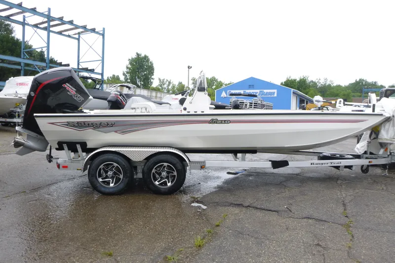 Slide: The Image of 2025 Ranger RB210 boat on trailer, parked outdoors, side view. - 3