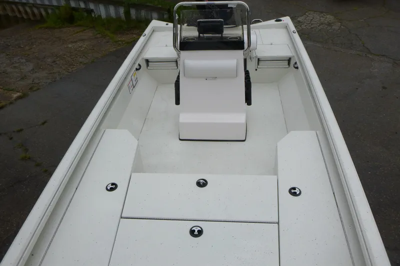 Slide: The Image of 2025 Ranger RB210 boat interior with white seating and storage compartments. - 5