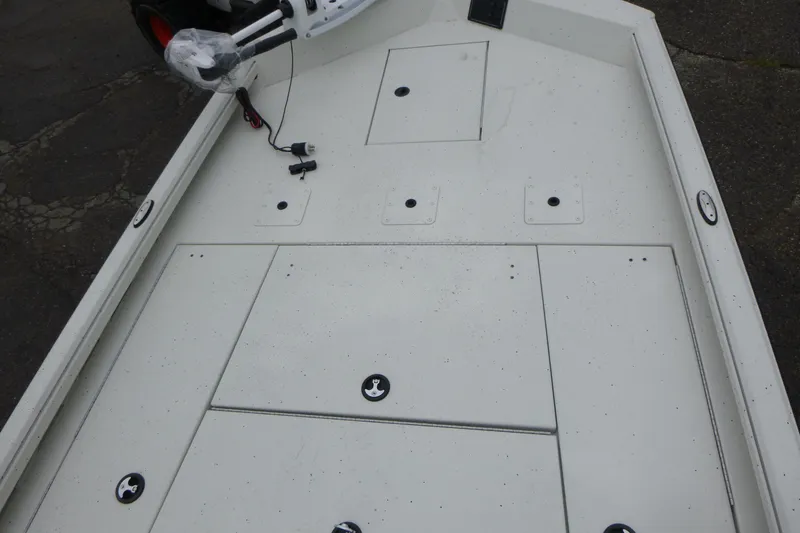 Slide: The Image of 2025 Ranger RB210 boat deck with storage compartments and fishing rod holders. - 6