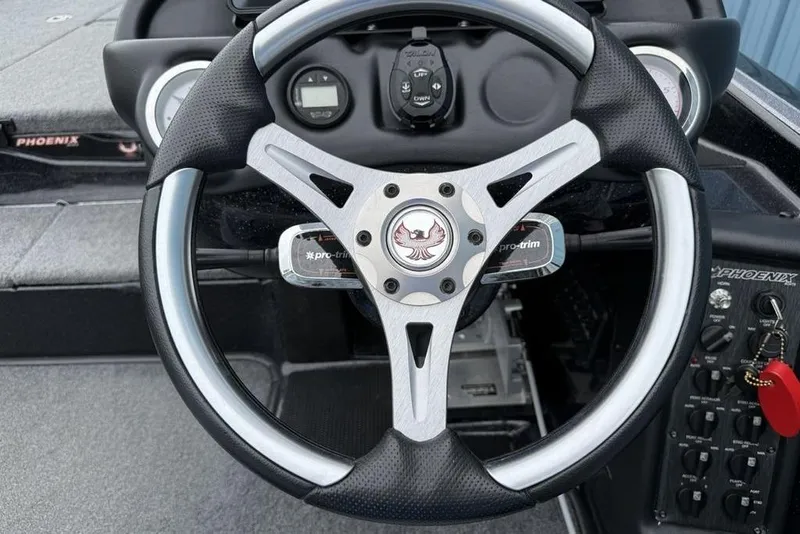 Slide: The Image of Steering wheel of 2019 Phoenix 921 PRO XP boat with dashboard controls. - 10