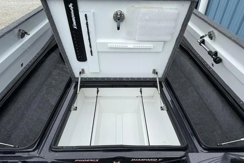 Slide: The Image of 2019 Phoenix 921 PRO XP boat storage compartment with organized interior and rod holders. - 15