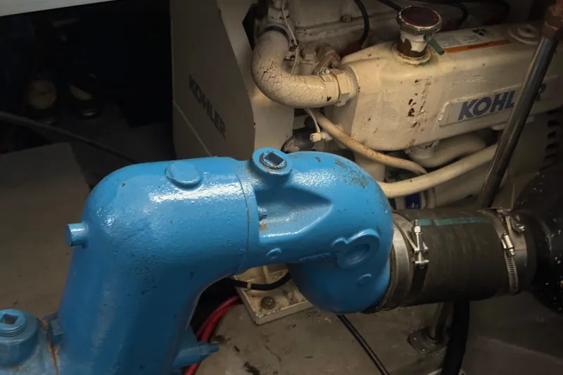 Slide: The Image of Engine room of 1990 Carver 3807 Aft Cabin with Kohler generator and blue exhaust pipe. - 11