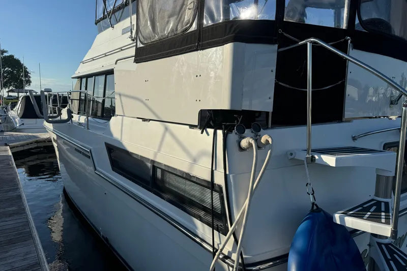 Slide: The Image of 1990 Carver 3807 Aft Cabin yacht docked at marina, side view. - 17
