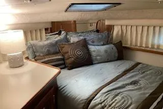 Slide: The Image of Cozy bedroom in 1990 Carver 3807 Aft Cabin with elegant bedding and soft lighting. - 2