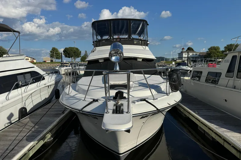 Slide: The Image of 1990 Carver 3807 Aft Cabin yacht docked at marina under blue sky. - 20