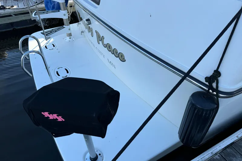 Slide: The Image of 1990 Carver 3807 Aft Cabin boat docked, featuring rear deck and protective fender. - 22