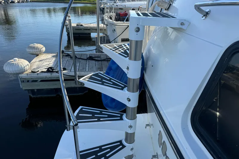 Slide: The Image of Staircase on 1990 Carver 3807 Aft Cabin yacht, docked by the water. - 23