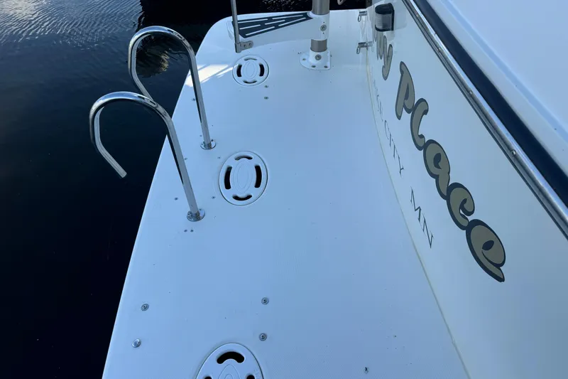 Slide: The Image of 1990 Carver 3807 Aft Cabin boat deck with ladder and water reflection. - 24