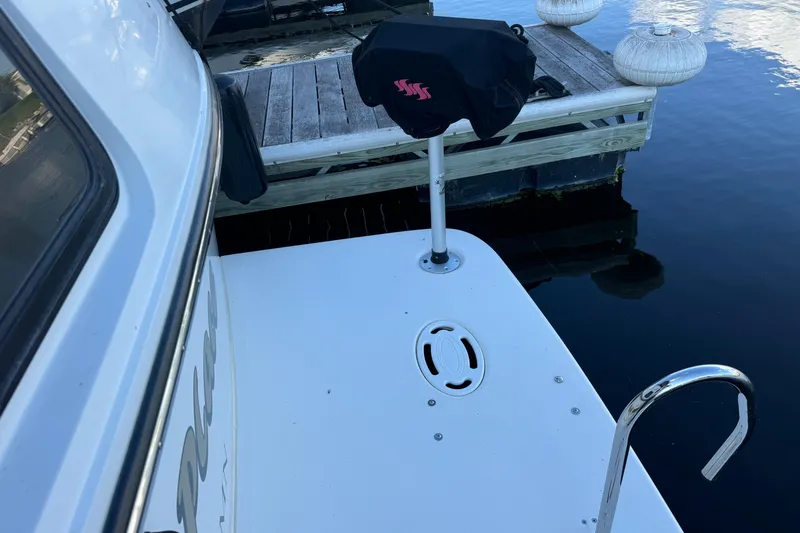 Slide: The Image of 1990 Carver 3807 Aft Cabin boat docked, featuring swim platform and covered equipment. - 25