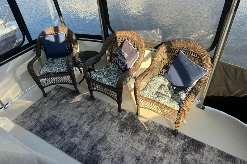 Slide: The Image of Wicker chairs with cushions on Carver 3807 Aft Cabin yacht, 1990 model, overlooking water. - 29