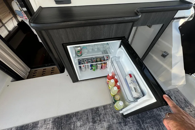 Slide: The Image of Mini fridge stocked with drinks on a 1990 Carver 3807 Aft Cabin yacht. - 31