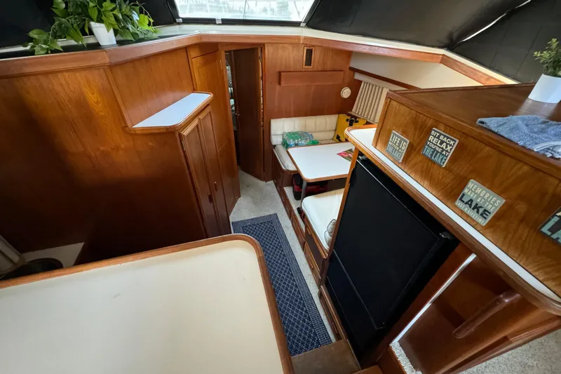 Slide: The Image of Interior of 1990 Carver 3807 Aft Cabin with wood paneling and cozy seating area. - 34