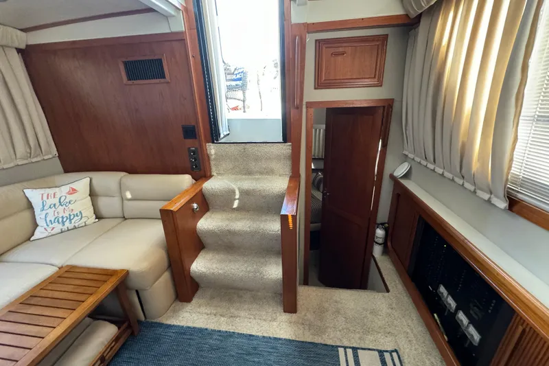 Slide: The Image of Interior of 1990 Carver 3807 Aft Cabin with cozy seating and carpeted stairs. - 36