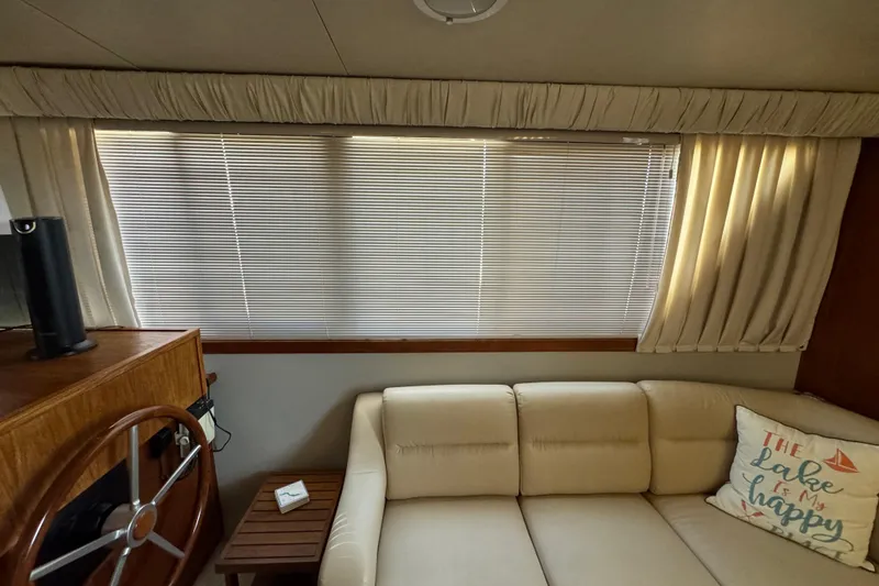 Slide: The Image of Interior of 1990 Carver 3807 Aft Cabin with beige sofa and nautical decor. - 37