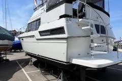 Slide: The Image of 1990 Carver 3807 Aft Cabin yacht on dry dock, showcasing its sleek design. - 4
