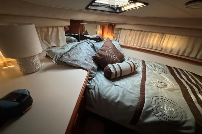 Slide: The Image of Cozy bedroom in 1990 Carver 3807 Aft Cabin yacht with elegant bedding and soft lighting. - 42
