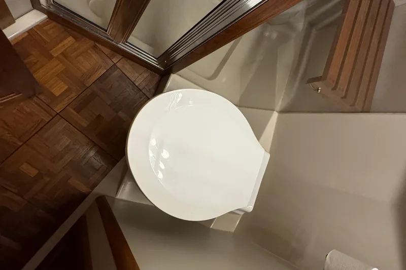 Slide: The Image of Toilet in 1990 Carver 3807 Aft Cabin yacht bathroom with wooden flooring. - 45