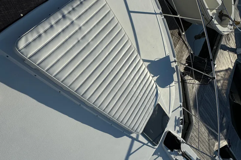 Slide: The Image of 1990 Carver 3807 Aft Cabin boat deck with cushioned seating and railing. - 5