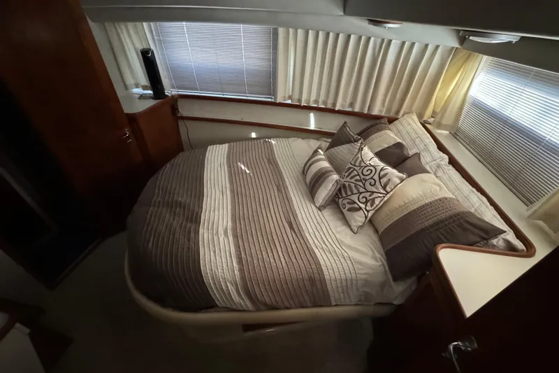 Slide: The Image of Cozy bedroom in 1990 Carver 3807 Aft Cabin with striped bedding and decorative pillows. - 51
