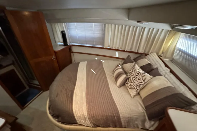 Slide: The Image of Cozy bedroom in 1990 Carver 3807 Aft Cabin with elegant bedding and wood accents. - 52