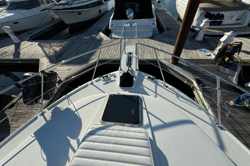 Slide: The Image of 1990 Carver 3807 Aft Cabin yacht docked at marina, view from bow. - 6