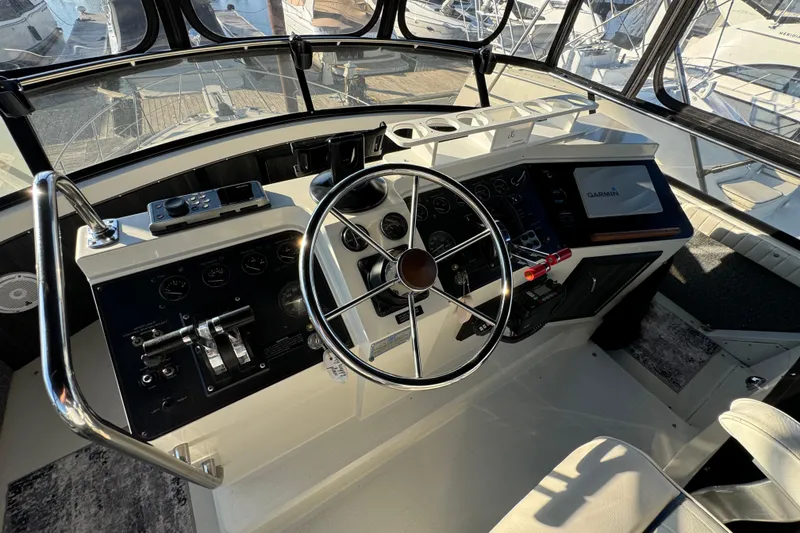 Slide: The Image of Interior helm of 1990 Carver 3807 Aft Cabin yacht with steering wheel and navigation equipment. - 64