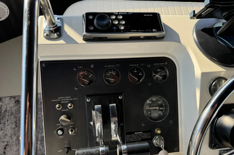 Slide: The Image of Control panel of a 1990 Carver 3807 Aft Cabin boat with gauges and controls. - 65