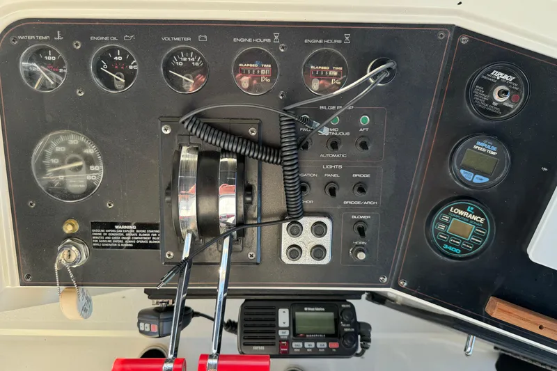 Slide: The Image of Control panel of a 1990 Carver 3807 Aft Cabin boat with gauges and switches. - 66