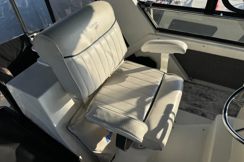 Slide: The Image of Captain's chair in 1990 Carver 3807 Aft Cabin yacht cockpit, white upholstery. - 68