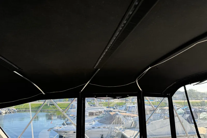 Slide: The Image of Interior view of 1990 Carver 3807 Aft Cabin with marina background. - 73