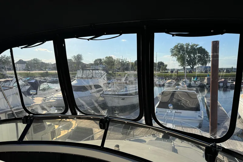 Slide: The Image of View from 1990 Carver 3807 Aft Cabin, overlooking marina with multiple boats docked. - 74