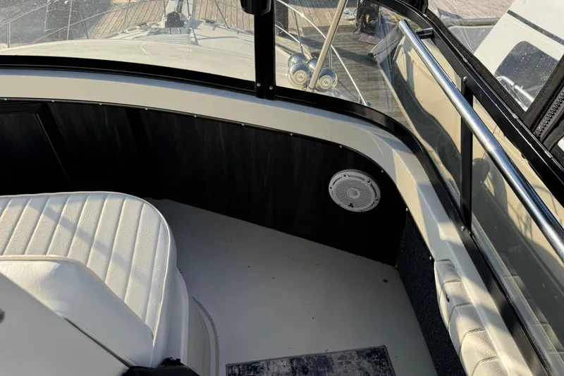 Slide: The Image of 1990 Carver 3807 Aft Cabin interior with white seating and speaker. - 75