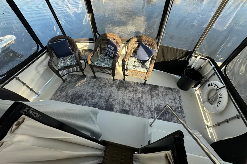 Slide: The Image of 1990 Carver 3807 Aft Cabin interior with wicker chairs and nautical decor. - 78