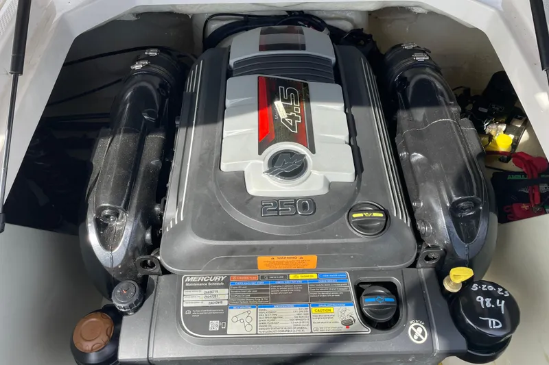 Slide: The Image of 2019 Chaparral 21 H2O Sport boat interior with white and brown seating. - 10