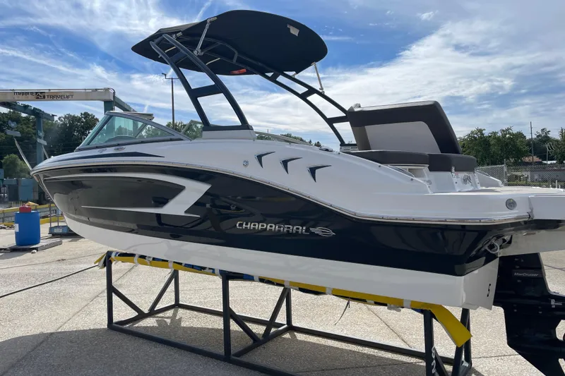 Slide: The Image of 2019 Chaparral 21 H2O Sport boat on display, featuring sleek design and black accents. - 12