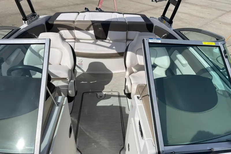 Slide: The Image of 2019 Chaparral 21 H2O Sport boat interior with white seating and windshield. - 15