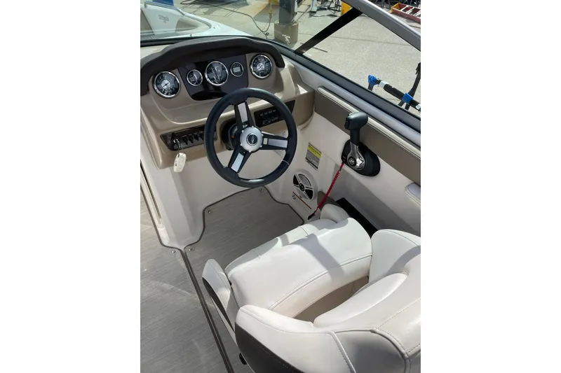 Slide: The Image of 2019 Chaparral 21 H2O Sport boat interior with white seating and dashboard. - 19