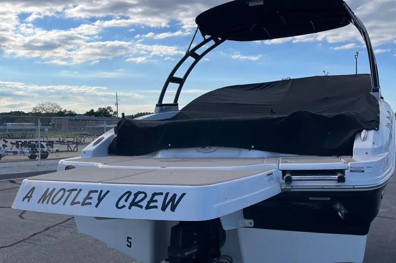 Slide: The Image of 2019 Chaparral 21 H2O Sport boat on trailer, parked near marina. - 3