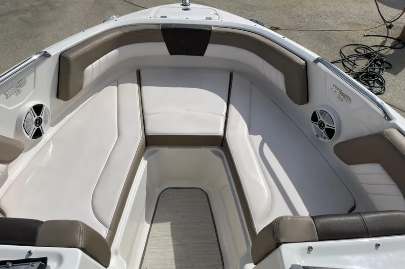 Slide: The Image of 2019 Chaparral 21 H2O Sport boat interior with cushioned seating and speakers. - 6