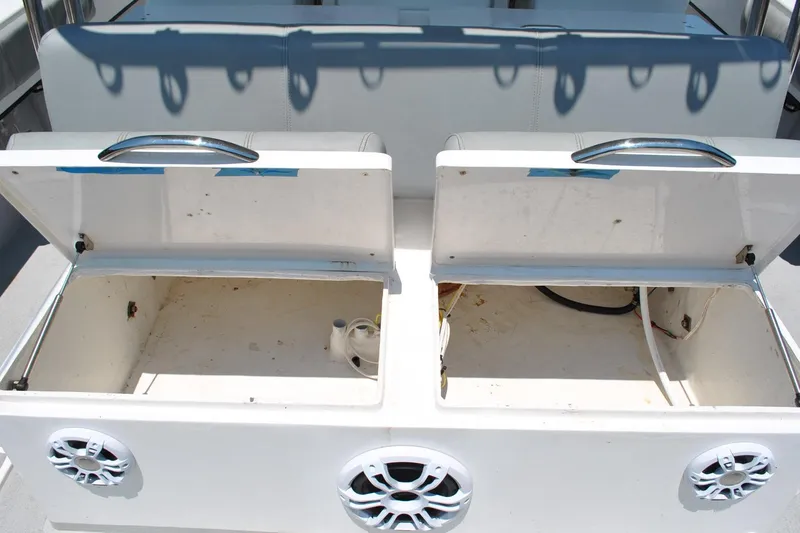 Slide: The Image of Open storage compartments on a 2024 TomCat 36 boat, featuring built-in speakers. - 13