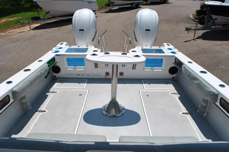 Slide: The Image of 2024 TomCat 36 boat interior with dual engines and central table, ideal for fishing trips. - 14