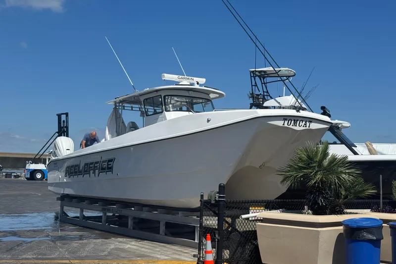Slide: The Image of 2024 TomCat 36 boat on dock, featuring sleek design and Garmin equipment. - 15