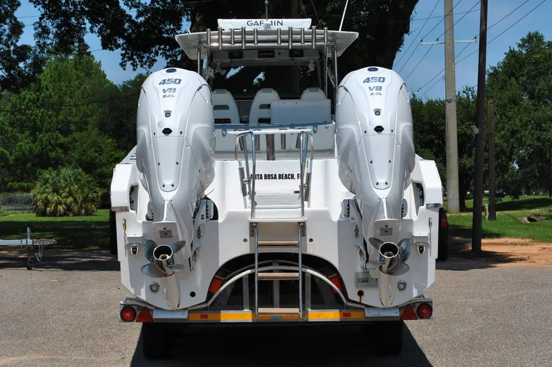 Slide: The Image of 2024 TomCat 36 boat with dual 450 V8 engines, parked outdoors. - 4