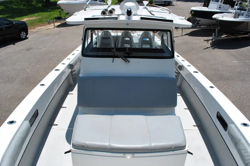 Slide: The Image of 2024 TomCat 36 boat with spacious seating and modern design in a marina setting. - 6