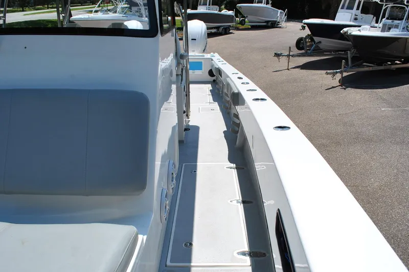 Slide: The Image of 2024 TomCat 36 boat interior with seating and deck, surrounded by other boats. - 8