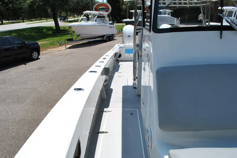 Slide: The Image of 2024 TomCat 36 boat docked, showcasing sleek design and spacious deck layout. - 9